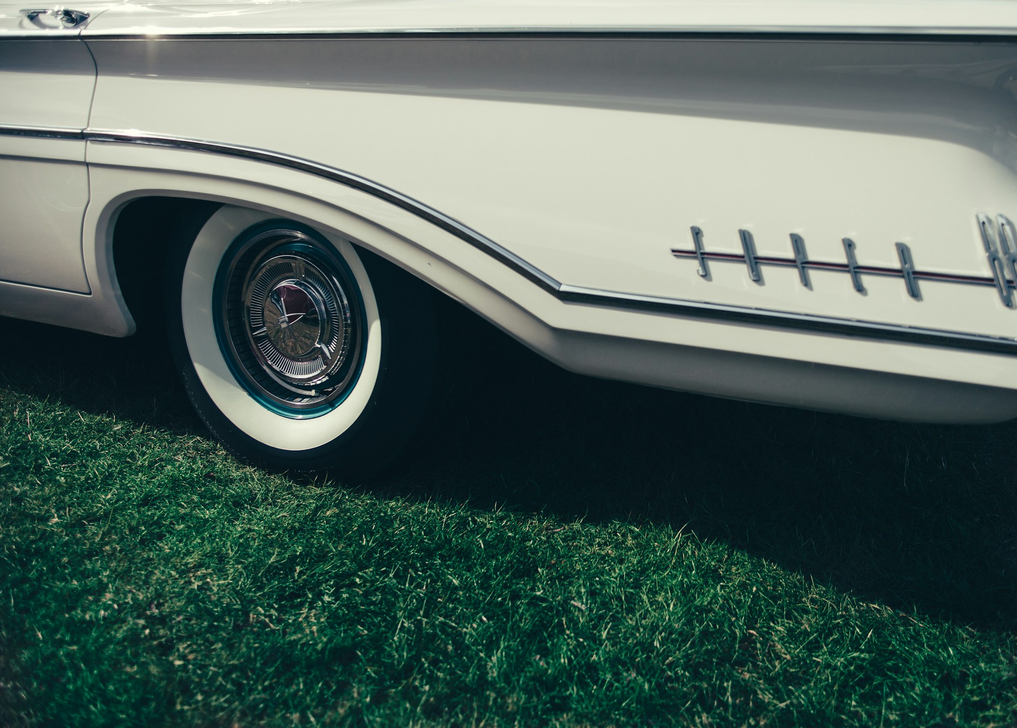 Whitewall tyre, polished chrome hub and tail-fin.